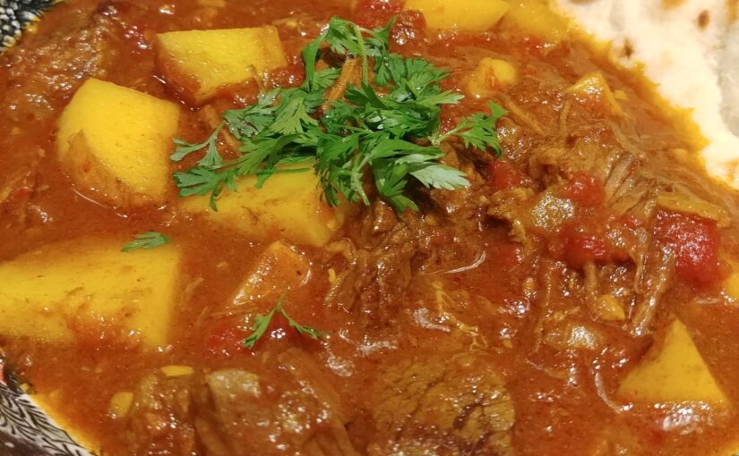 Beef Curry with Potatoes, served with naan.